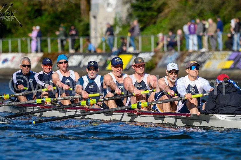 Crew rowing shell containing eight racers, competing in a race.
